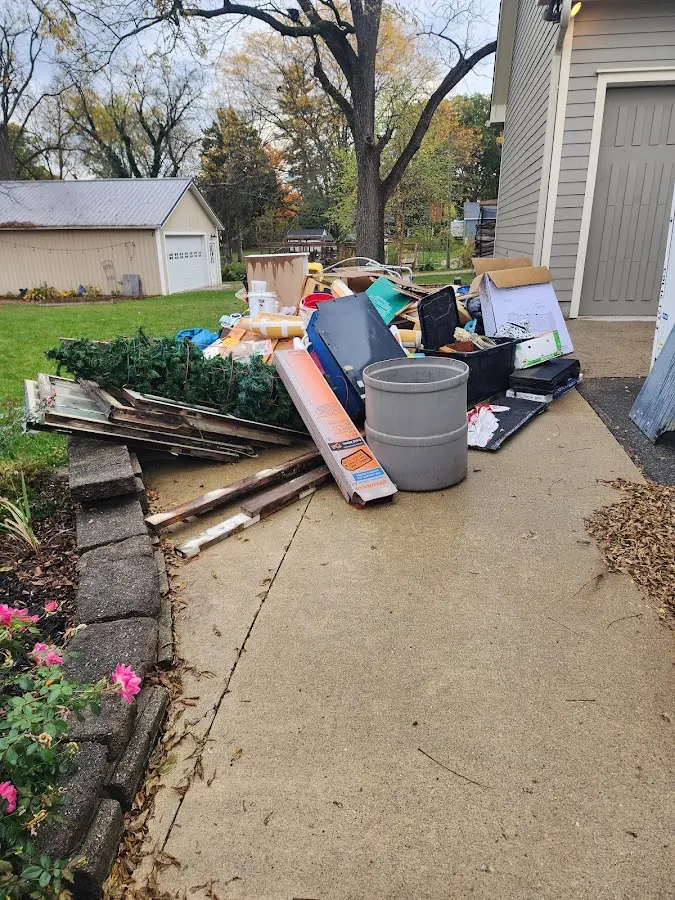 Dumpster being loaded with debris for Commercial Dumpster Rental in Bethany